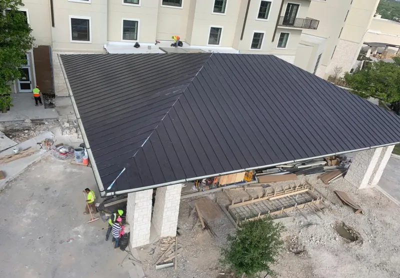Metal roofing installation team working on a commercial building in White Oak